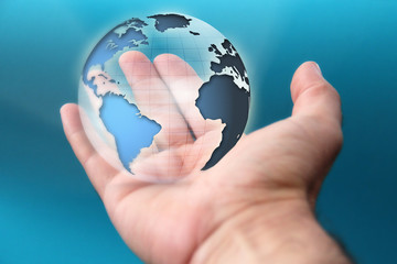 A human hand holding Earth and focusing on America, Europe and Africa