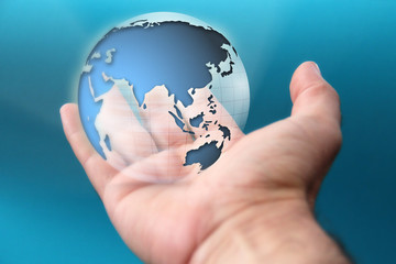 A hand is holding planet earth. Concept on global issues like climate change or countries cooperation