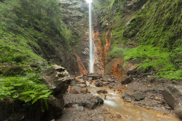 small waterfall among the forest in val di Funes