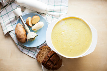 mashed potato soup with bread on   table