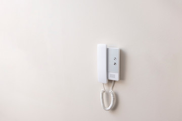 White intercom on a wall
