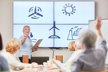 Dozentin und Senioren im Kurs über Alternative Energien in der Erwachsenenbildung