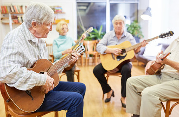 Gruppe Senioren im Gitarrenkurs in der Freizeit oder als Beschäftigungstherapie