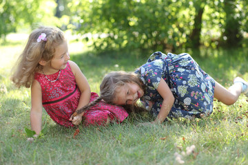 cute little sisters having fun in garden.