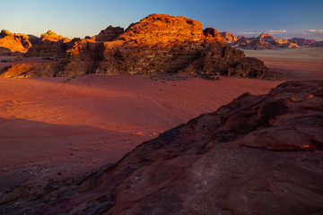 WADI RUM DESERT, JORDAN - FEBRUARY 06, 2020: Sunset over the massif of Jebel Khash and strange red rocks
