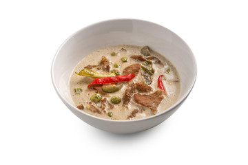 Thai curry in white bowl on white background