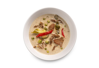 Thai curry in white bowl on white background