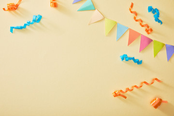 top view of festive colorful confetti on beige background