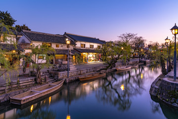 Fototapeta na wymiar Kurashiki Bikan Historical Quarter in dusk. Townscape known for characteristically Japanese white walls of residences and willow trees lining banks of Kurashiki River. Okayama Prefecture, Japan