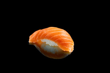 Classic japanese sushi with salmon on a black background with reflection. Photo for the menu