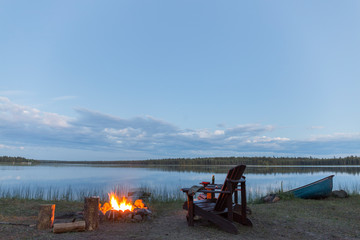 bonfire lit the lake of a lake at dusk