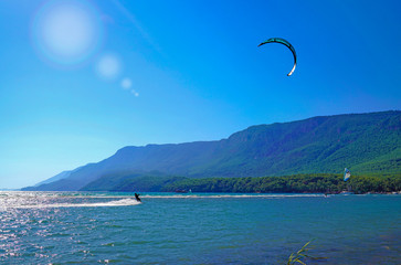 Akyaka, Mugla/Turkey-August 14 2018: Surfer enjoying kite surfing at the beach where Azmak River...