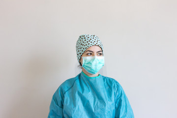 Nurse dressed with protections for coronavirus, with personalized surgical cap.