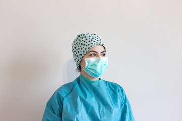 Nurse dressed with protections for coronavirus, with personalized surgical cap.