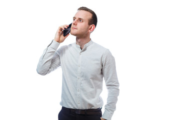 Fototapeta premium Caucasian man businessman, teacher mentor, talking on the phone and makes a selfie. He is wearing a shirt. Emotional portrait. Isolated on white background