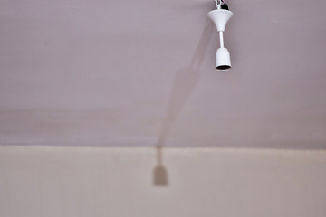 Bulb holder hanging on the ceiling. Empty is not plugged in.