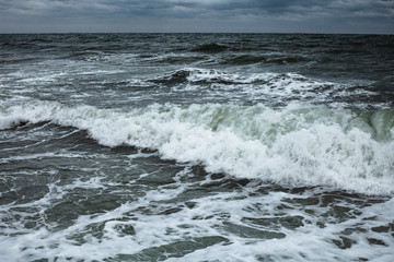 Dark clouds and the crash of sea waves during a storm in the Black Sea in Odessa.Art photo 
