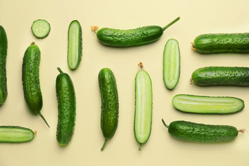 Green cucumbers on color background