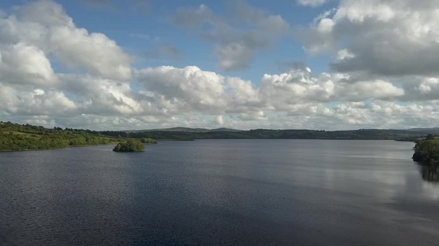 aerial of lake and fluffy clouds