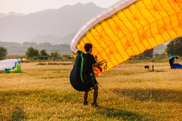 A man on a paraglider prepares to fly