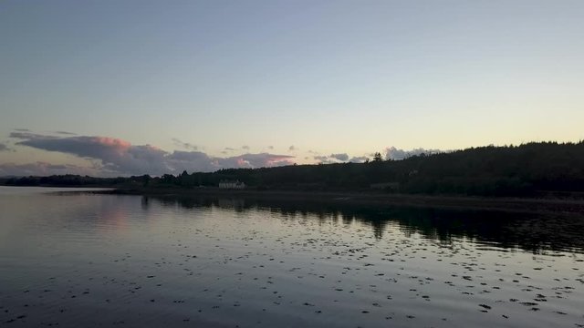 Late aerial sunset over quiet lake rising