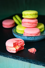 still life, pink and pistachio macaroons on a black tray