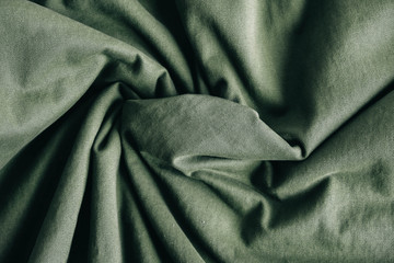 Green fabric texture as background image. Top view. Copy, empty space for text