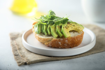 Avocado on toast with fresh arugula