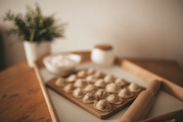 Raw dumpling with meat. Preparation dumplings on a wooden board.