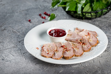Boiled pork with sauce on a white glass plate