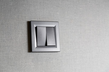 Two-key switch gray on the wall a plastic mechanical switch. Light switch installed after repair....