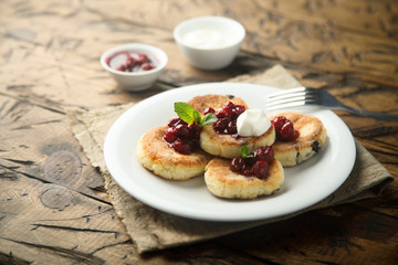 Homemade cottage cheese cakes with cherry sauce