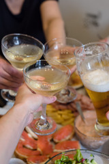 Friends and family people hands toasting white wine at the festive table