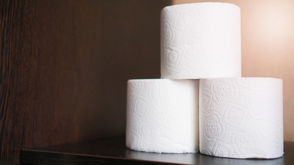 Toilet paper is consider a must item during crisis. Tissue rolls on dark background for copyspace