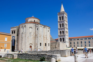 Fototapeta na wymiar Roman Forum of Zadar, Croatia, with the Bell Tower of the Cathedral of St. Anastasia and the Church of St. Donatus at the background