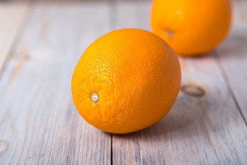 Two orange on a wooden background close-up