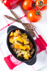 Food concept Homemade French organic Ratatouille in white bake ceramic bowl on blask slate stone board © TYSB