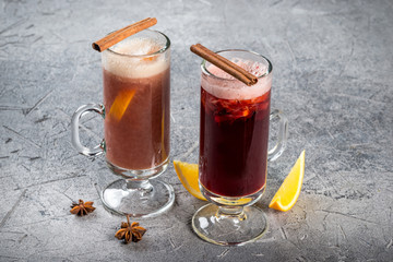 Mulled wine in a glass, tall, transparent glass with cinnamon and lemon