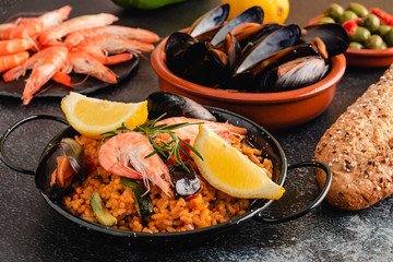 Paella traditional Spanish food, served on tapa plate