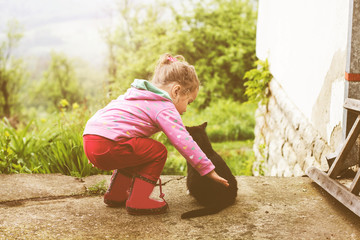 Friends Little Girl Playing With Cat Outdoor