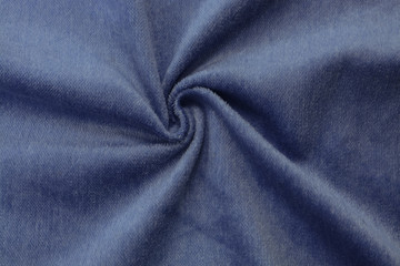 Fototapeta na wymiar Corduroy blue background in close up. Texture of soft corduroy textile - useful as background
