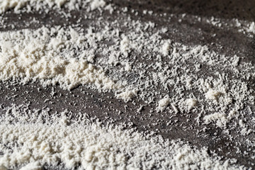 Baking flat lay on the table, flour on a gray background. Bake menu, recipe, home baking concept. Top view with copy space for your text.
