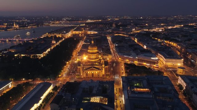 From great height beautiful night downtown cityscape St. Petersburg historical centre Saint Isaac's Cathedral backlight. Old streets road traffic. Neva river. Open space horizon. Best landmarks. Drone