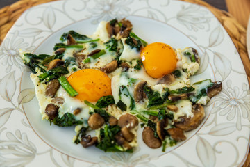 sunny side up eggs with mushrooms and spinach. Fresh eggs, omelet