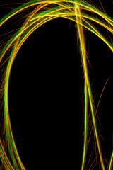 abstract shiny golden lines with black background.light painting patterns with long exposure.