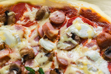 slice of pizza with sausage and mushrooms closeup