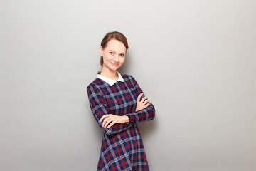 Obraz premium Portrait of cheerful girl holding arms crossed on chest and smiling