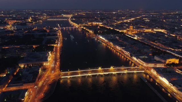 Helicopter forward night central cityscape St. Petersburg historical Russia best downtown illumination. Epic Neva river reflection, drawbridges. Road traffic cars. Admiralty, Saint Isaac's Cathedral