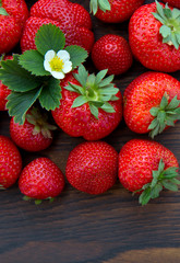 Macro shot on strawberries over wooden background.