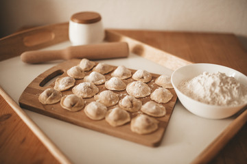 Raw dumpling with meat. Preparation dumplings on a wooden board.